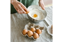 Image Eggs breaking into dough.
